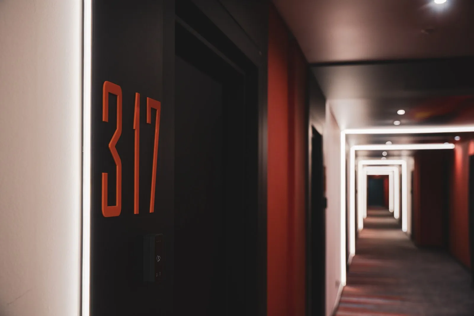 A corridor with new carpet and room signage